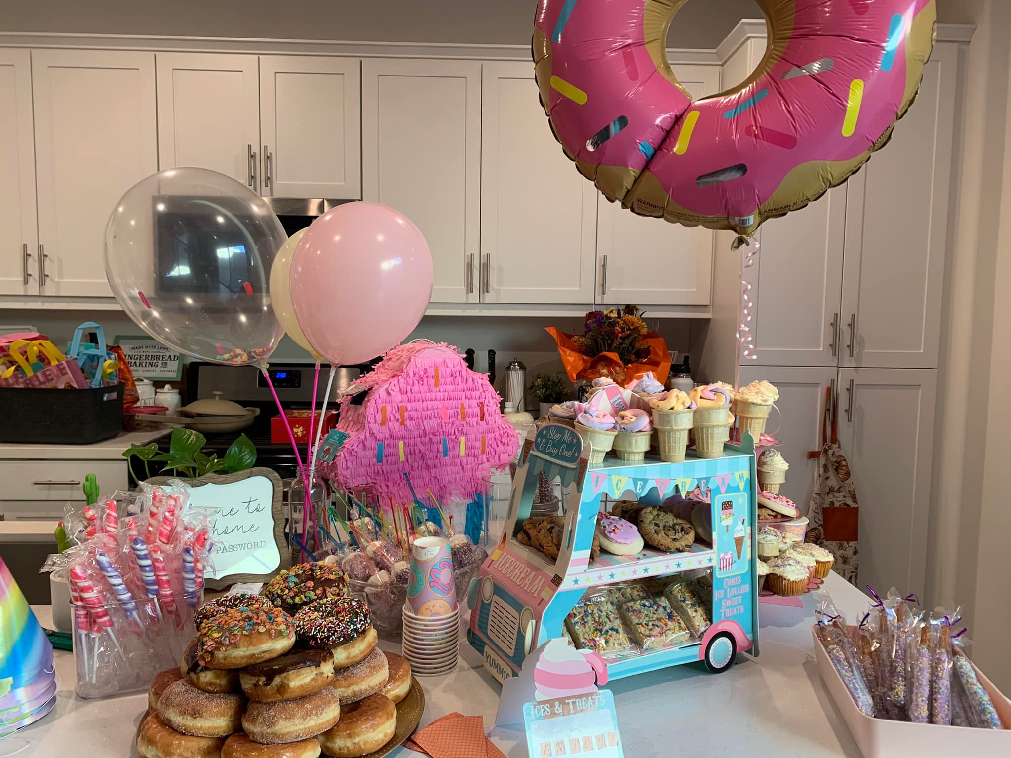 a variety of treats and baked goods alongside baked good themed decorations