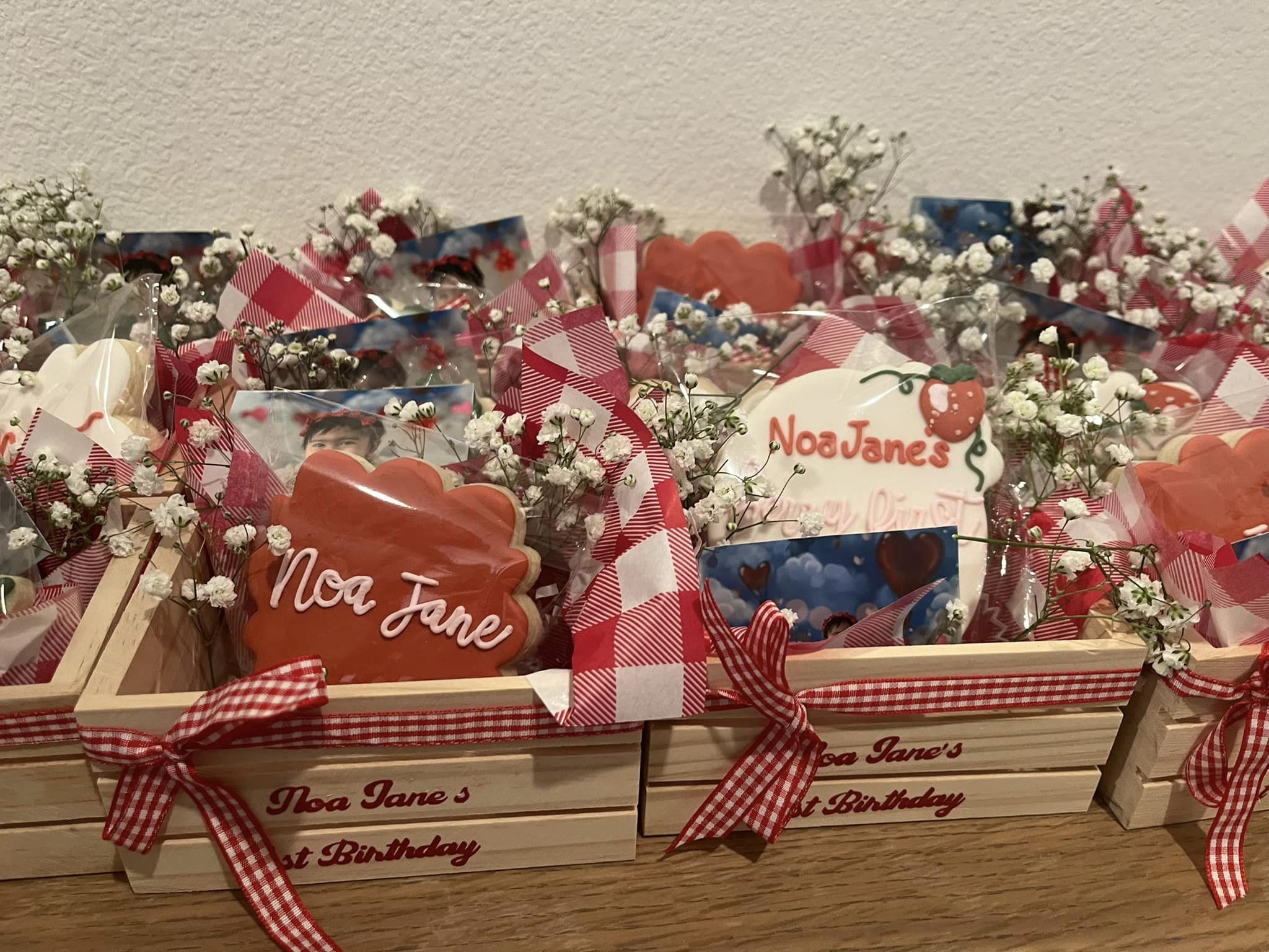 Gift baskets with flowers, custom cookies, and photos to be given out at a child's birthday